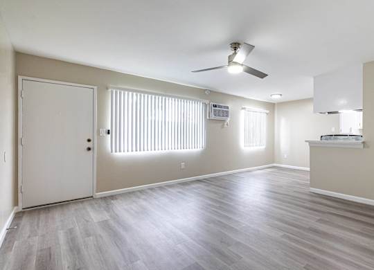an empty living room with wood floors and a ceiling fan at Colima Terrace Apts, Rowland Heights