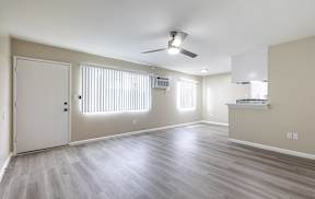 an empty living room with wood floors and a ceiling fan at Colima Terrace Apts, Rowland Heights