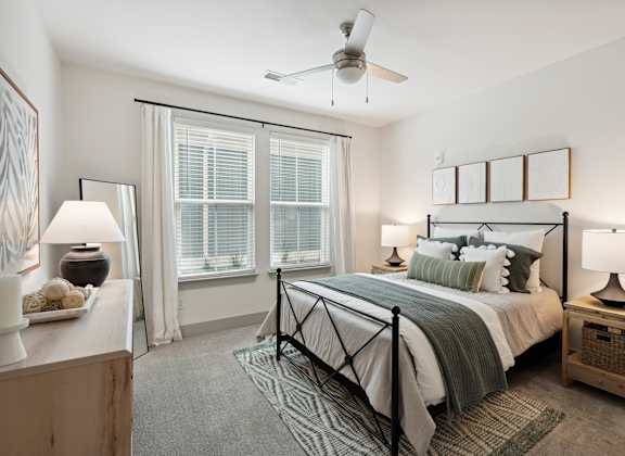 a bedroom with a bed and a ceiling fan
