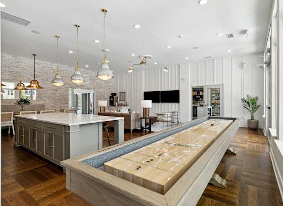 a large kitchen with a bar and a living room