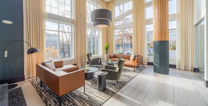 A modern lobby  with a large window and a view of the city  at Heights at Glen Mills, Glen Mills, PA