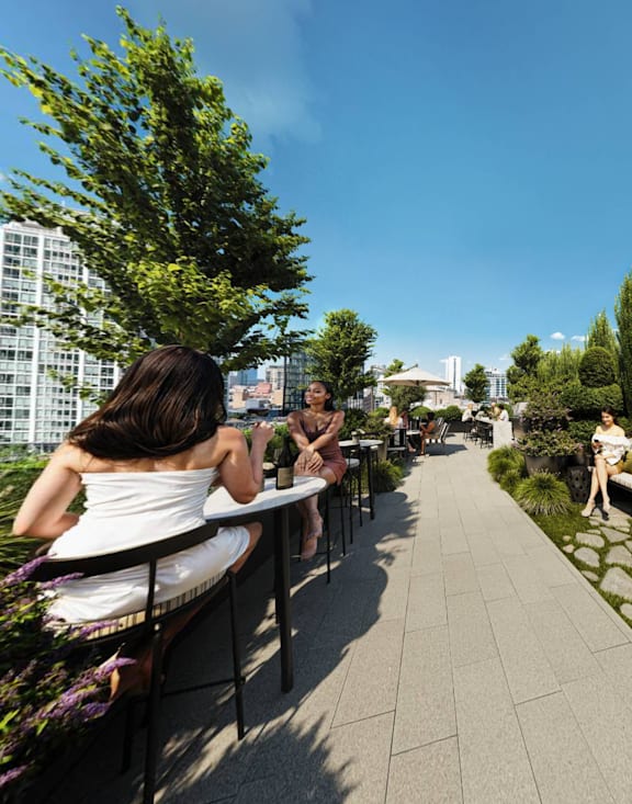 People are sitting on a rooftop terrace with a cityscape view at Chateau on Wells, Chicago, Illinois