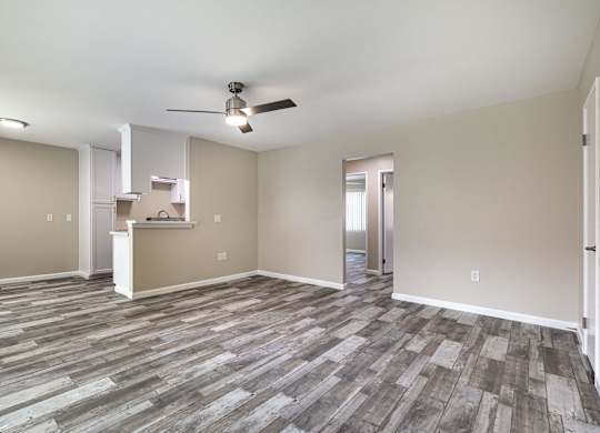 an empty living room with vinyl flooring and a ceiling fan at Colima Terrace Apts, Rowland Heights California