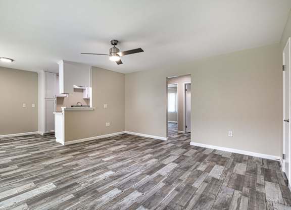 an empty living room with vinyl flooring and a ceiling fan at Colima Terrace Apts, Rowland Heights California