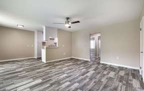 an empty living room with vinyl flooring and a ceiling fan at Colima Terrace Apts, Rowland Heights California