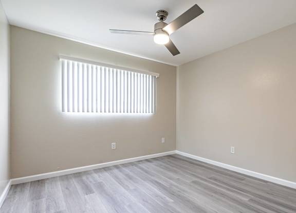 an empty living room with wood floors and a ceiling fan  at Colima Terrace Apts, Rowland Heights, CA 91748