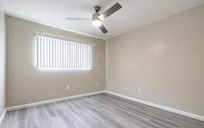 an empty living room with wood floors and a ceiling fan  at Colima Terrace Apts, Rowland Heights, CA 91748