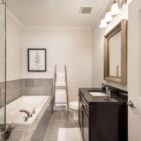 a bathroom with a tub and a sink and a mirror at Arlo Luxury homes Apartments, Little Rock, Arkansas