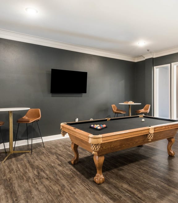 a games room with a pool table and a tv at Arlo Luxury homes Apartments, Little Rock, Arkansas