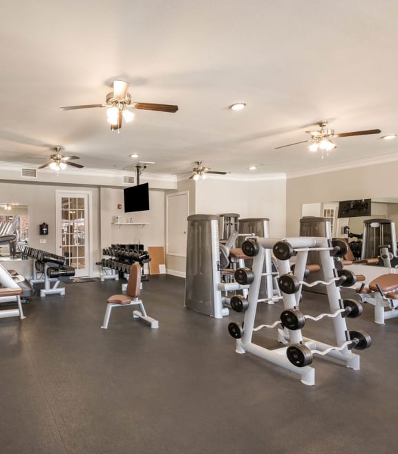 a gym with weights equipment and a ceiling fan at Arlo Luxury homes Apartments, Little Rock, Arkansas