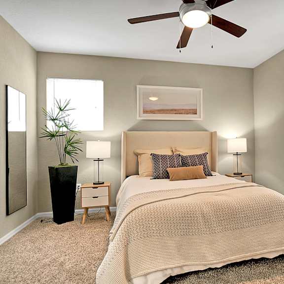 A bedroom with a large bed and a wooden dresser.
