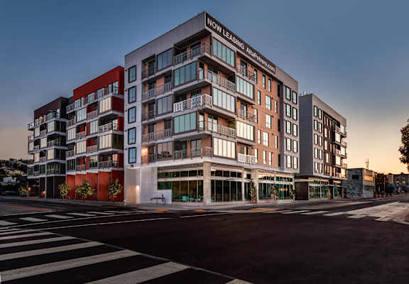 A modern multi-story building with the words "OW Leasing" on the top.