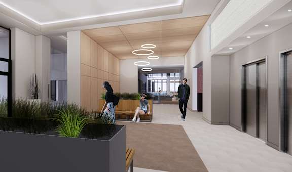 A modern hallway with people walking and sitting.
