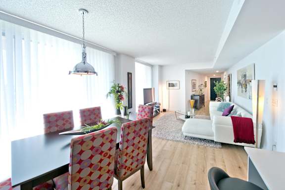 A dining room with a table and chairs.
