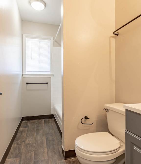 A bathroom with a white sink and a mirror above it.