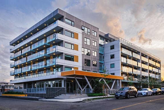 a large office building with cars parked in front of it