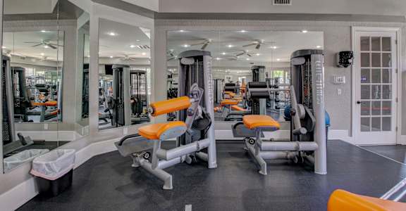 A gym with orange and grey equipment.