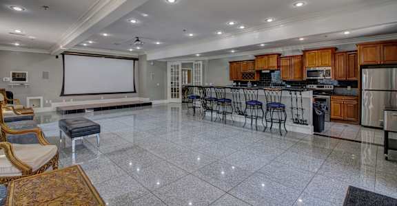 A spacious kitchen and dining area with a large island and bar stools.