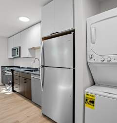 A modern kitchen with a refrigerator and oven.