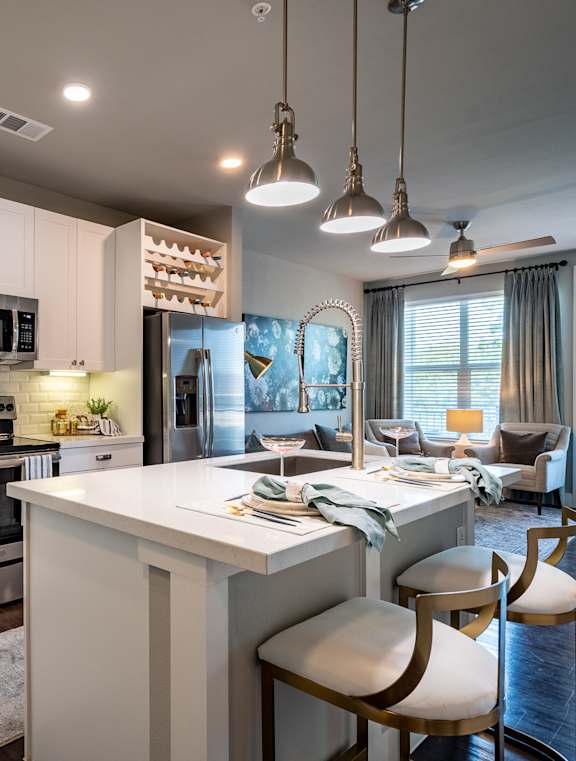 A modern kitchen with white cabinets and a large island.
