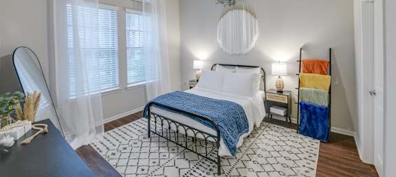 a bedroom with a bed and a ceiling fan