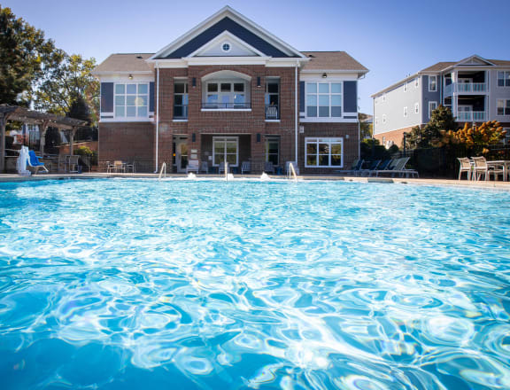 a large swimming pool in front of a house
