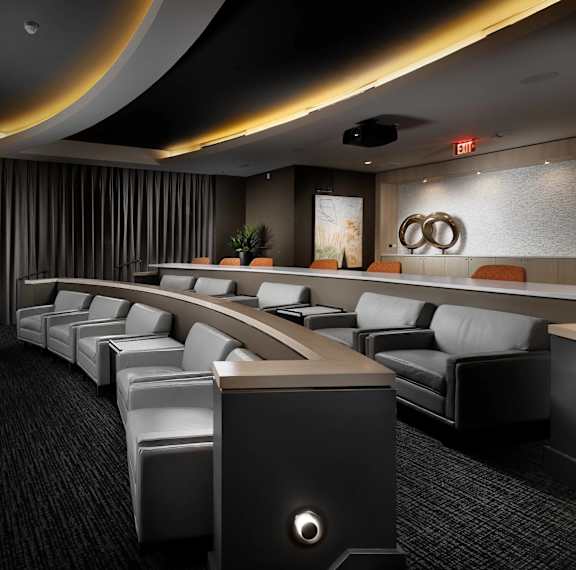 A modern conference room with a long table and chairs.