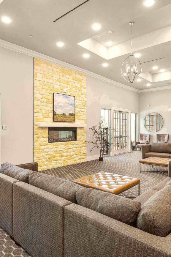 a large living room with couches and a fireplace