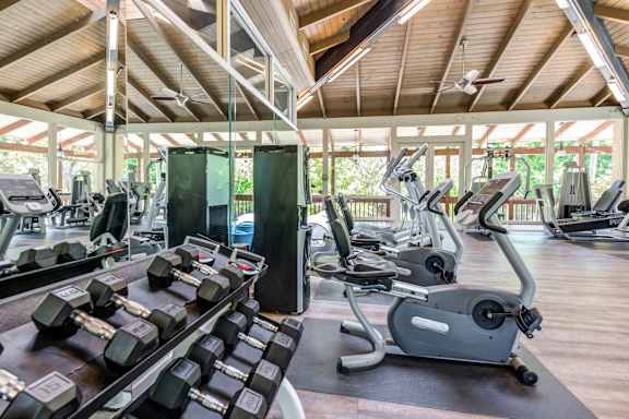 a gym with cardio equipment and weights