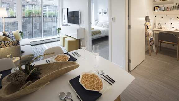 A modern dining area with a table set for two.