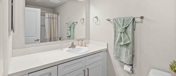 Bathroom with sink and mirror at Timbre Apartments, Lakewood, Washington