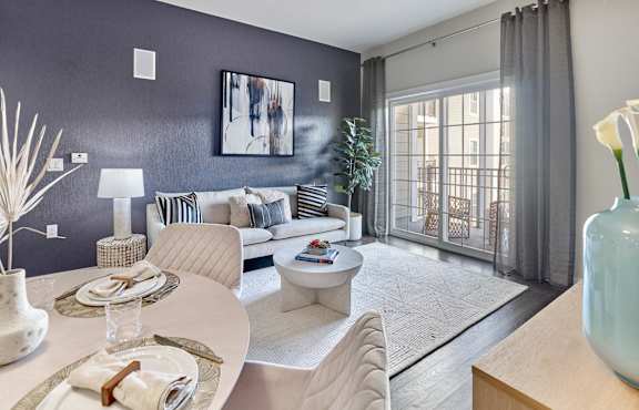 A dining room with a table set for two and a couch in the background. at Vermella Lyndhurst apartments, Lyndhurst, NJ, 07071