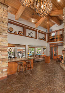 a large living room with a fireplace and a kitchen at Lodge of Overland Park Apartments, Overland Park , 66212