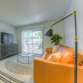 a living room with a couch and a rug in the middle at Brightwaters Apartments, Little Rock, Arkansas