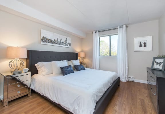 a bedroom with a large bed and a window