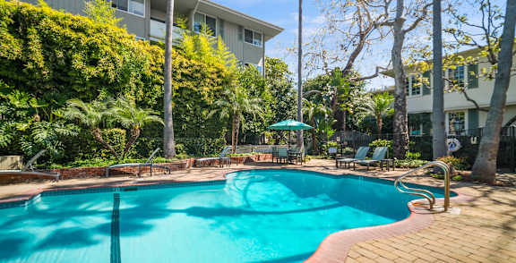 a large swimming pool in front of an apartment building  at Sunset Barrington Gardens, Los Angeles, CA, 90049