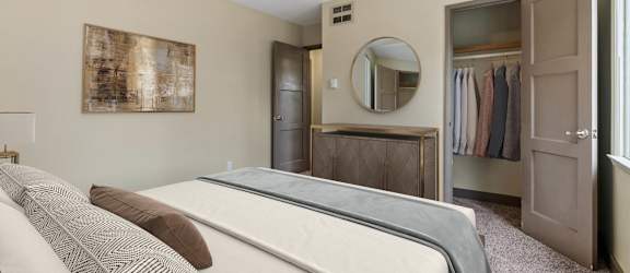 A bedroom with a bed, wardrobe, and a mirror.