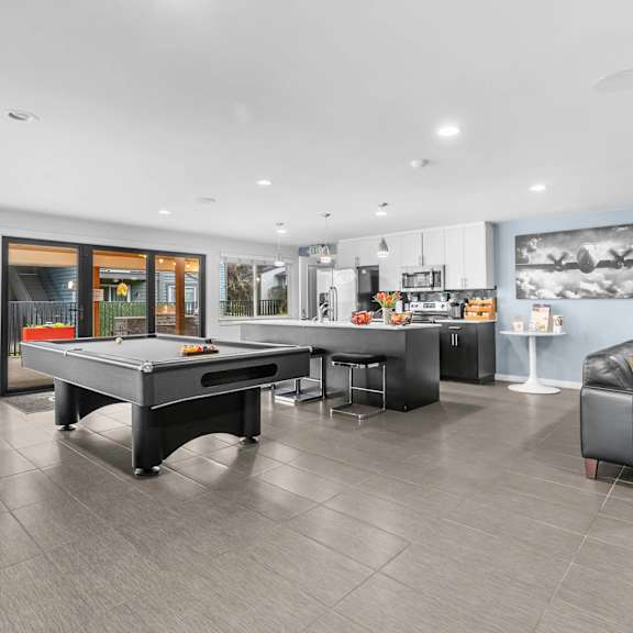 a game room with a pool table and a tv