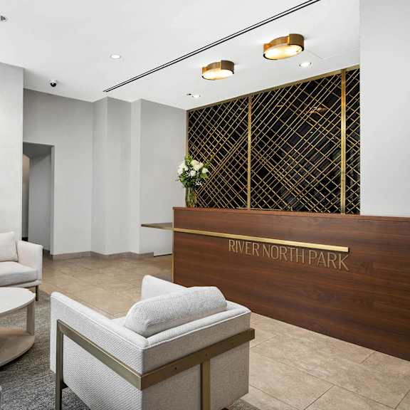 A reception area with a fireplace and chairs.