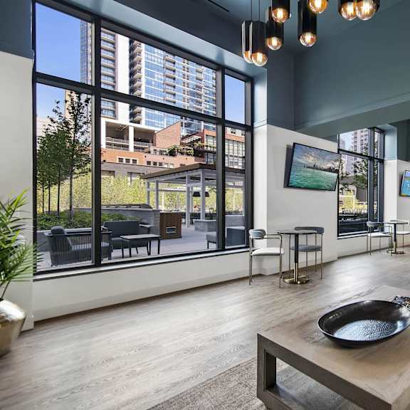 A modern living room with a large window overlooking the city.