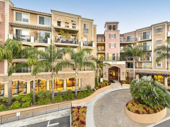 a courtyard with palm trees in front of an apartment building at Marina Harbor, Marina del Rey, CA, 90292