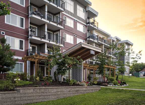 a rendering of a new apartment building with a green yard