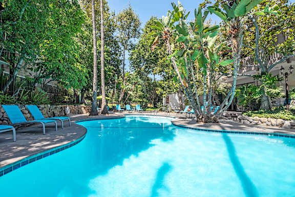 a swimming pool at a resort with trees and chairs  at Rancho Los Feliz, Los Angeles, 90039