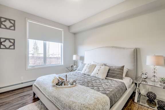 a bedroom with a large bed and a window