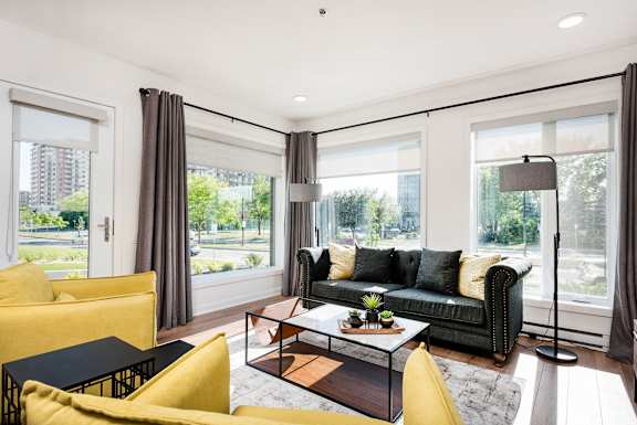 a living room with a black couch and a coffee table