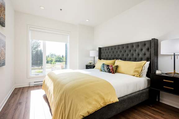a bedroom with a large bed and a window