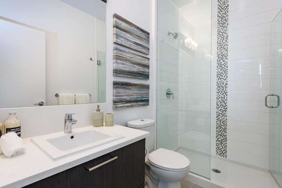 a bathroom with a sink toilet and shower