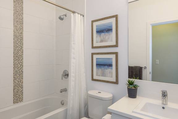 a bathroom with a shower and a toilet and a sink