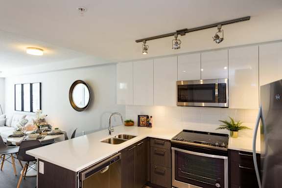a kitchen with an island and a sink and a microwave