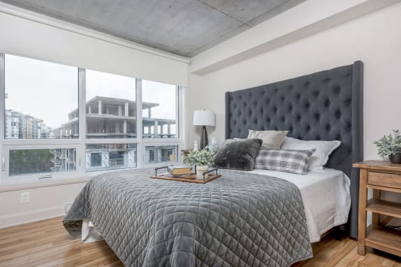 a bedroom with a large bed and a large window